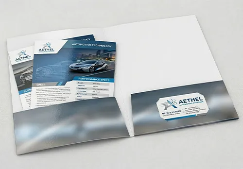 Inside view of an open blank two-pocket presentation folder showing horizontal pockets and die-cut business card slits 